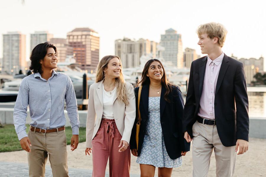 Students from the business administration BSBA program walk along the intercoastal in West Palm Beach.